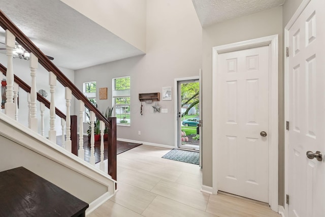 5191 Hialeah Ct, Columbus, OH 43221 - entryway with baseboards, stairway, and a textured ceiling