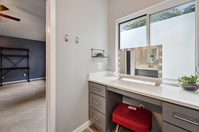 5191 Hialeah Ct, Columbus, OH 43221 - home office featuring built in desk, a ceiling fan, light carpet, a sink, and baseboards