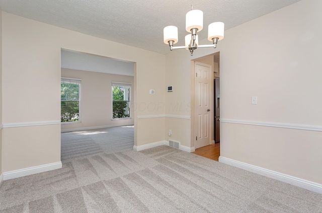 8732 Eastfield Ct, Pickerington, OH 43147 - carpeted spare room with a chandelier and a textured ceiling