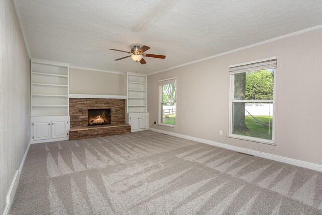 8732 Eastfield Ct, Pickerington, OH 43147 - unfurnished living room featuring carpet flooring, plenty of natural light, a ceiling fan, a textured ceiling, and built in features