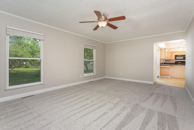 8732 Eastfield Ct, Pickerington, OH 43147 - unfurnished living room featuring healthy amount of natural light, ornamental molding, light colored carpet, ceiling fan, and a textured ceiling