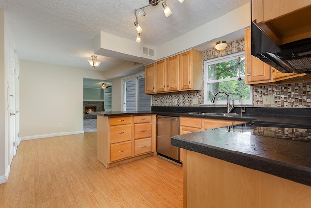 8732 Eastfield Ct, Pickerington, OH 43147 - kitchen with dishwasher, a peninsula, dark countertops, light wood-type flooring, and backsplash