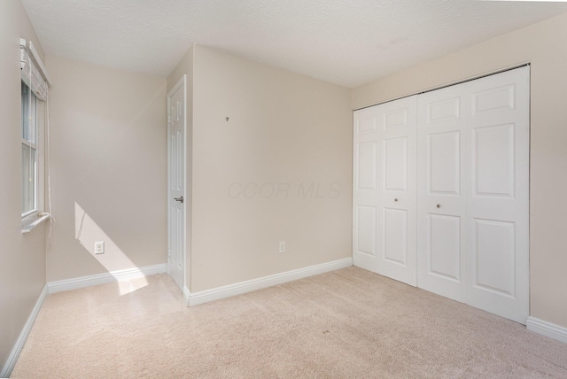 8732 Eastfield Ct, Pickerington, OH 43147 - unfurnished bedroom with carpet floors, a closet, and a textured ceiling