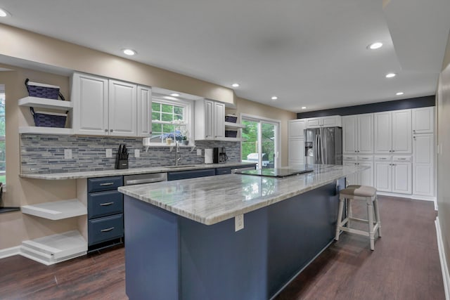 68 Nadine Pl N, Westerville, OH 43081 - kitchen with open shelves, stainless steel fridge with ice dispenser, a breakfast bar, white cabinetry, and recessed lighting