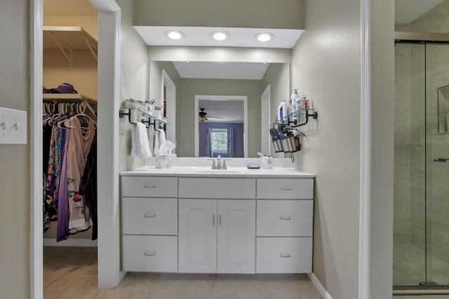 68 Nadine Pl N, Westerville, OH 43081 - bathroom featuring vanity, a shower stall, a spacious closet, and ceiling fan