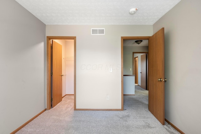 4686 Gilman Rd, Columbus, OH 43228 - carpeted spare room with a textured ceiling, baseboards, and a smoke detector