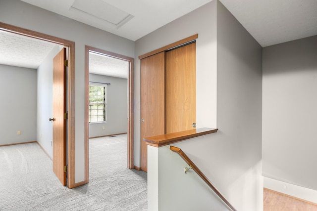 4686 Gilman Rd, Columbus, OH 43228 - corridor with attic access, baseboards, and light colored carpet