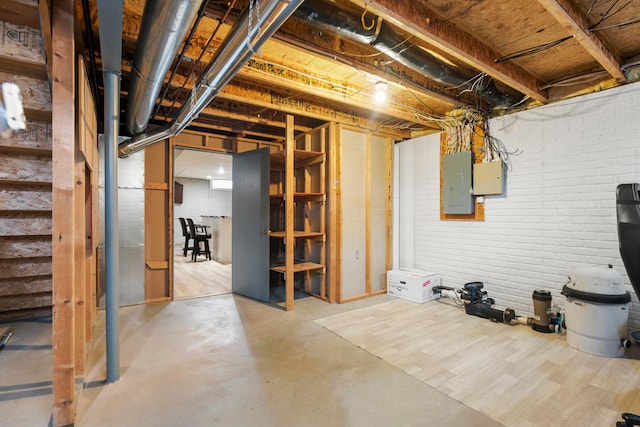 4686 Gilman Rd, Columbus, OH 43228 - unfinished basement featuring electric panel, stairway, and brick wall