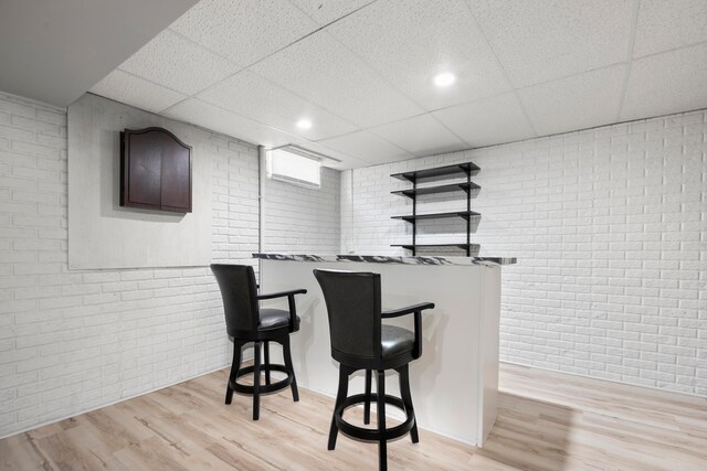 4686 Gilman Rd, Columbus, OH 43228 - indoor dry bar with brick wall, a paneled ceiling, light wood-type flooring, and baseboards