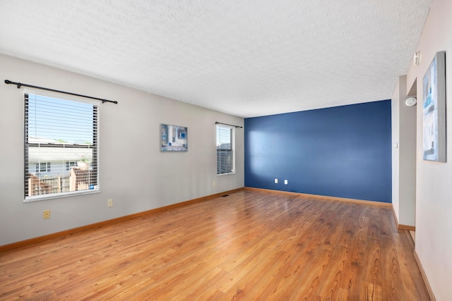 4686 Gilman Rd, Columbus, OH 43228 - empty room featuring a textured ceiling, wood finished floors, and baseboards