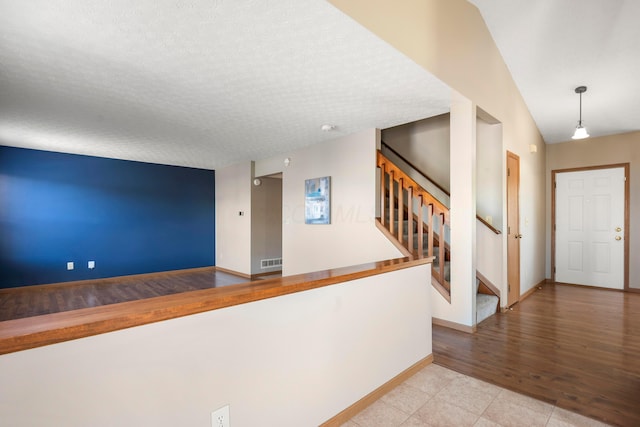 4686 Gilman Rd, Columbus, OH 43228 - entryway with stairway, baseboards, and a textured ceiling