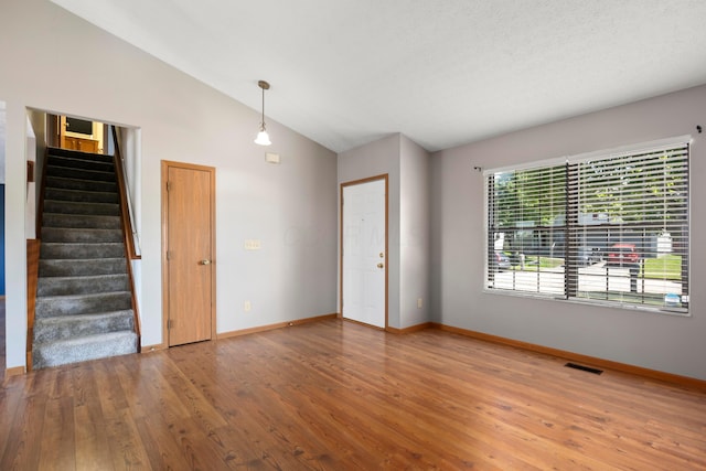 4686 Gilman Rd, Columbus, OH 43228 - spare room featuring vaulted ceiling, stairway, wood finished floors, and baseboards