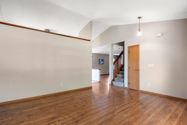 4686 Gilman Rd, Columbus, OH 43228 - empty room featuring vaulted ceiling, stairway, wood finished floors, and baseboards