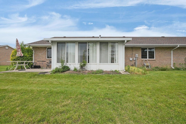 452 Samantha Cir Unit 10, London, OH 43140 - back of property featuring brick siding, a lawn, a patio area, and a sunroom