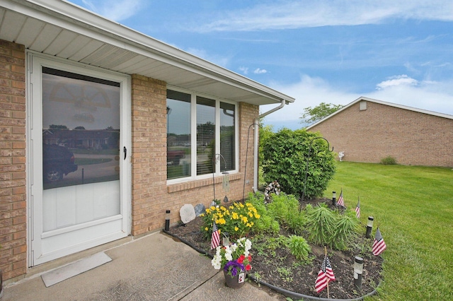 452 Samantha Cir Unit 10, London, OH 43140 - view of exterior entry featuring brick siding and a yard