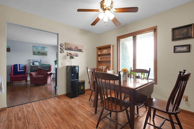 452 Samantha Cir Unit 10, London, OH 43140 - dining room with light wood-style flooring, a ceiling fan, and baseboards