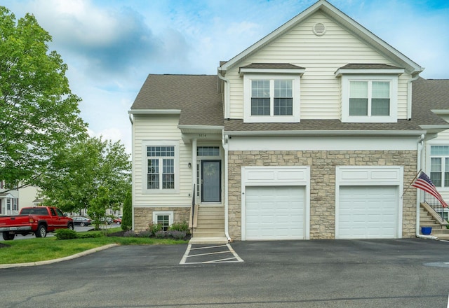 5834 Aristides Way Unit 10, New Albany, OH 43054 - townhome / multi-family property featuring asphalt driveway, stone siding, a garage, and roof with shingles