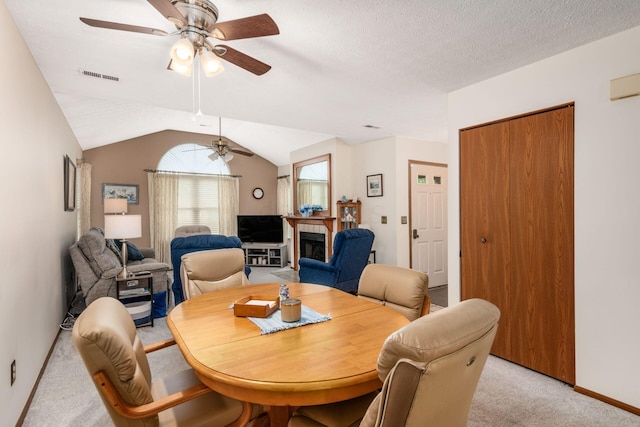 2423 Hooverside Ln, Grove City, OH 43123 - dining space with ceiling fan, light carpet, a fireplace, baseboards, and lofted ceiling