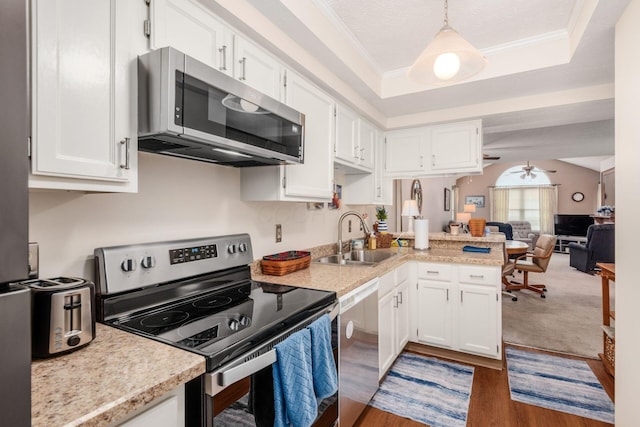 2423 Hooverside Ln, Grove City, OH 43123 - kitchen with appliances with stainless steel finishes, a sink, white cabinetry, light countertops, and ornamental molding