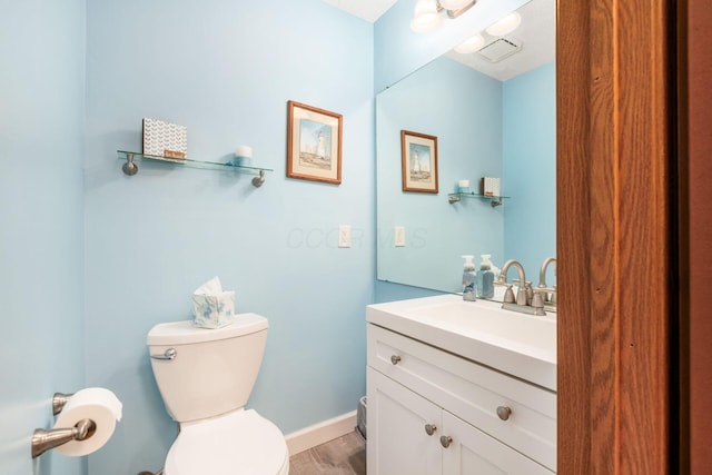 2423 Hooverside Ln, Grove City, OH 43123 - half bath with toilet, vanity, baseboards, and wood finished floors