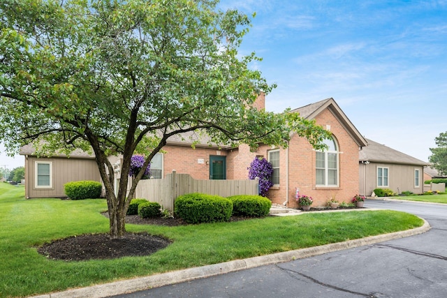 2423 Hooverside Ln, Grove City, OH 43123 - view of property hidden behind natural elements featuring a chimney and brick siding