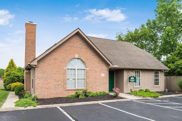 2423 Hooverside Ln, Grove City, OH 43123 - view of front facade with a chimney, uncovered parking, and brick siding