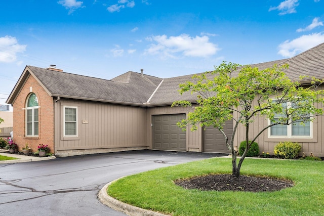 2423 Hooverside Ln, Grove City, OH 43123 - view of front of home with roof with shingles, a garage, asphalt driveway, and a front lawn