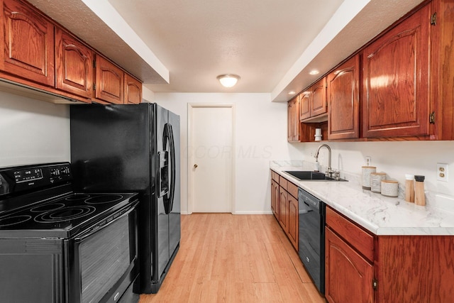 815 Savannah Dr, Columbus, OH 43228 - kitchen featuring black appliances, light wood-style floors, light countertops, and brown cabinetry
