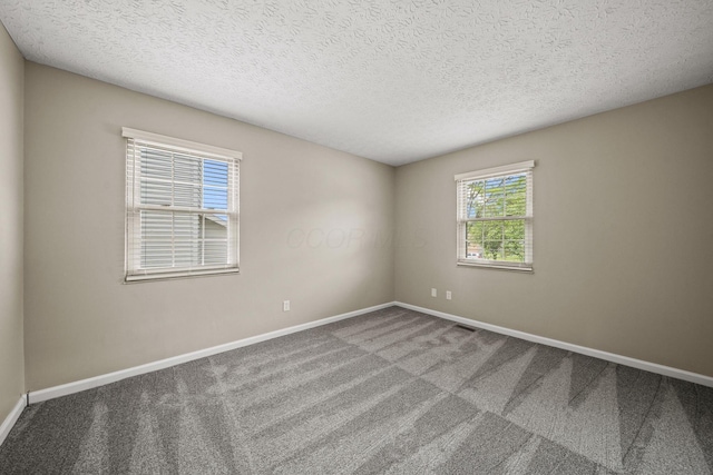 4150 Demorest Rd, Grove City, OH 43123 - carpeted spare room with baseboards and a textured ceiling