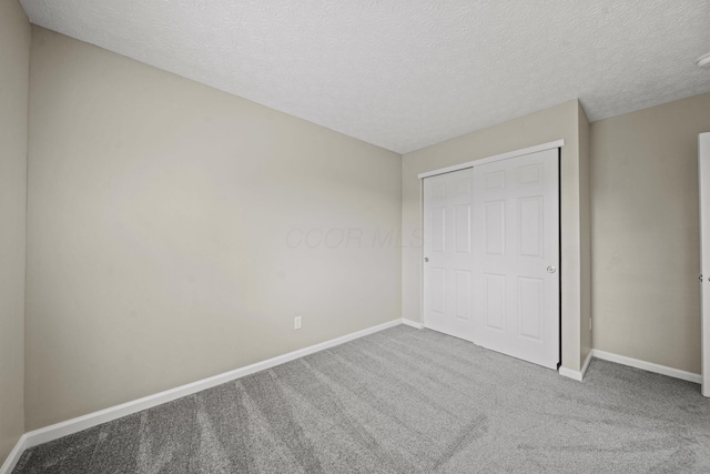 4150 Demorest Rd, Grove City, OH 43123 - unfurnished bedroom with baseboards, carpet flooring, a textured ceiling, and a closet