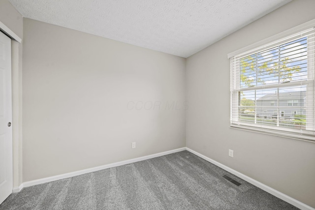 4150 Demorest Rd, Grove City, OH 43123 - carpeted empty room with baseboards and a textured ceiling