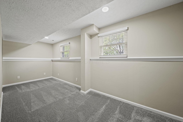 4150 Demorest Rd, Grove City, OH 43123 - empty room with a textured ceiling, carpet flooring, healthy amount of natural light, and baseboards