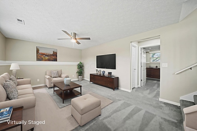4150 Demorest Rd, Grove City, OH 43123 - living room featuring a ceiling fan, carpet, baseboards, and a textured ceiling