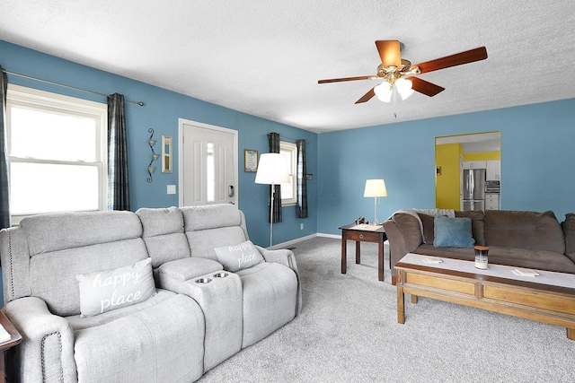 13111 King Rd NE, Thornville, OH 43076 - living room featuring ceiling fan, carpet floors, a textured ceiling, and baseboards