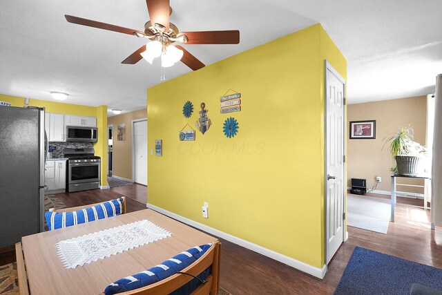 13111 King Rd NE, Thornville, OH 43076 - dining room with a ceiling fan, dark wood-type flooring, and baseboards