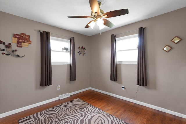 13111 King Rd NE, Thornville, OH 43076 - unfurnished room with wood finished floors, healthy amount of natural light, ceiling fan, and baseboards