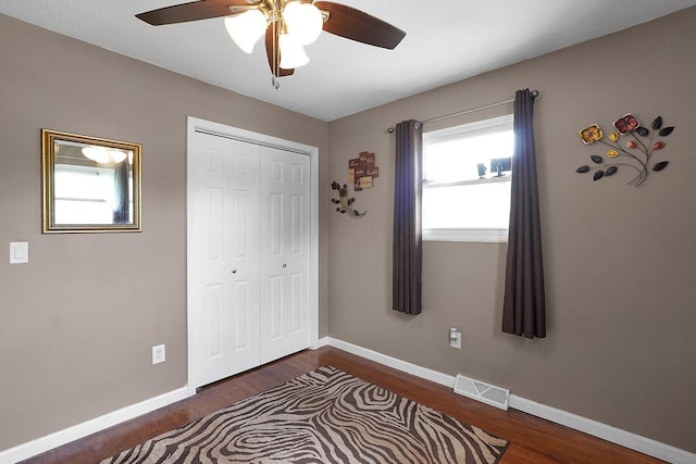 13111 King Rd NE, Thornville, OH 43076 - unfurnished bedroom featuring dark wood-type flooring, a closet, baseboards, and ceiling fan