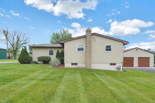 13111 King Rd NE, Thornville, OH 43076 - rear view of house featuring an outdoor structure, a yard, a garage, and a chimney