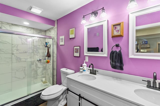 565 S Kellner Rd, Columbus, OH 43209 - full bathroom featuring double vanity, a stall shower, and toilet