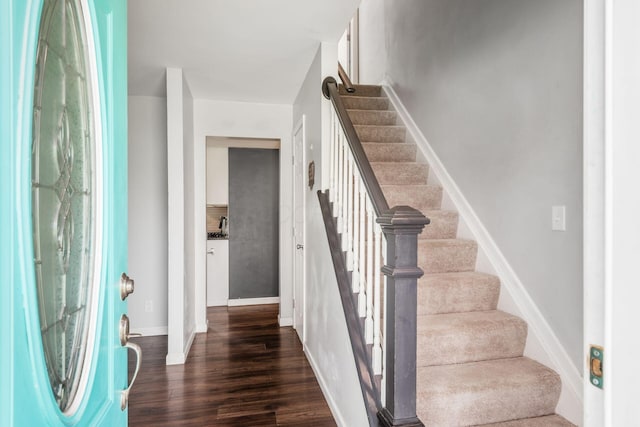 5186 Meadowbrook Dr, Columbus, OH 43207 - foyer entrance featuring stairs, dark wood finished floors, and baseboards