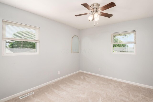 5186 Meadowbrook Dr, Columbus, OH 43207 - spare room featuring plenty of natural light, light carpet, and baseboards