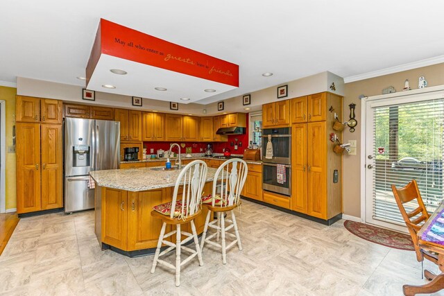 445 Cedar Hill Rd SW, Amanda, OH 43102 - kitchen with stainless steel appliances, under cabinet range hood, brown cabinetry, light stone countertops, and ornamental molding