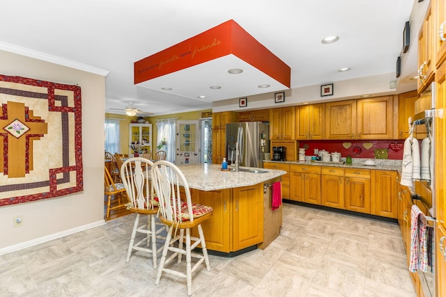 445 Cedar Hill Rd SW, Amanda, OH 43102 - kitchen featuring stainless steel appliances, brown cabinetry, light stone countertops, a center island with sink, and ornamental molding