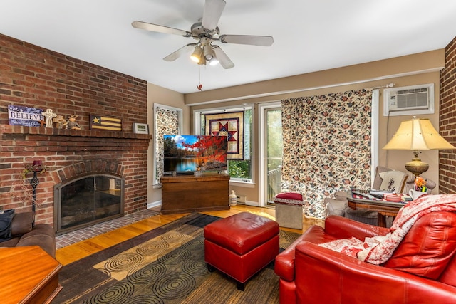 445 Cedar Hill Rd SW, Amanda, OH 43102 - living area featuring wood finished floors, ceiling fan, a brick fireplace, and a wall mounted AC