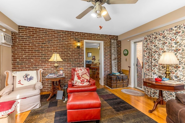 445 Cedar Hill Rd SW, Amanda, OH 43102 - living room featuring wood finished floors, brick wall, and ceiling fan