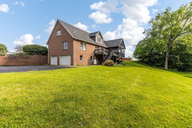 445 Cedar Hill Rd SW, Amanda, OH 43102 - back of property with brick siding, a garage, driveway, a deck, and a lawn