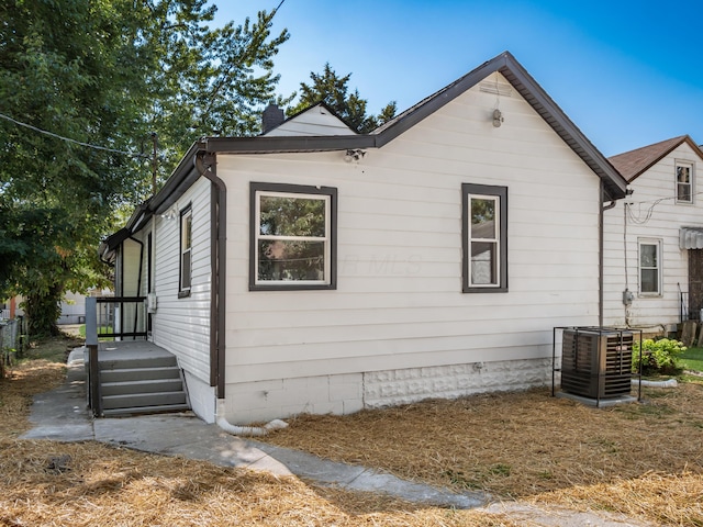 1432 Cordell Ave, Columbus, OH 43211 - view of home's exterior with a cooling unit and a chimney