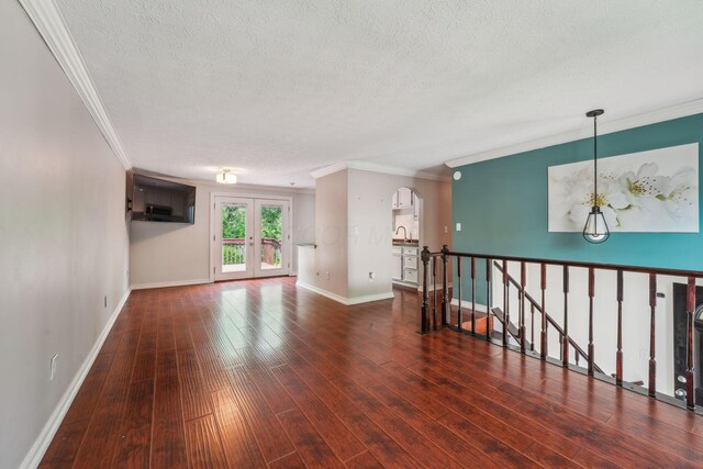 3840 Farm Brook Ln, Columbus, OH 43204 - unfurnished room featuring a textured ceiling, hardwood / wood-style flooring, crown molding, arched walkways, and french doors