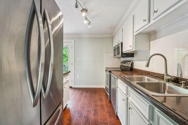3840 Farm Brook Ln, Columbus, OH 43204 - kitchen with appliances with stainless steel finishes, dark countertops, backsplash, dark wood-style floors, and ornamental molding