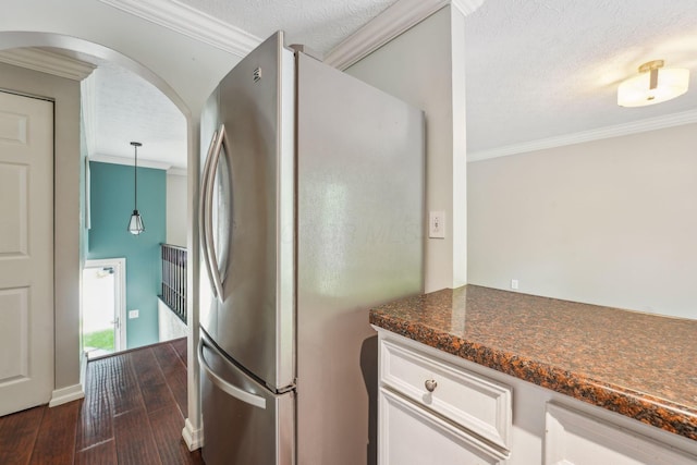 3840 Farm Brook Ln, Columbus, OH 43204 - kitchen with freestanding refrigerator, crown molding, dark wood-style floors, arched walkways, and white cabinetry